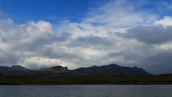 Mountains in the Background of Gray Clouds Fresh Lake in the Valley Between the Mountains