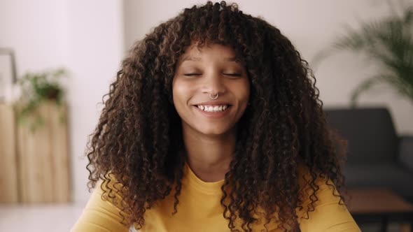 Happy Young African American Woman Talking to Camera on Video Call From Home