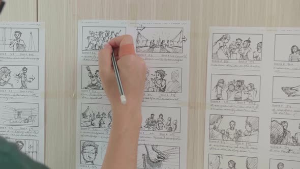 Asian Man Drawing Storyboard Animation Comic Cartoon, Design Creative Scene Layout At Studio