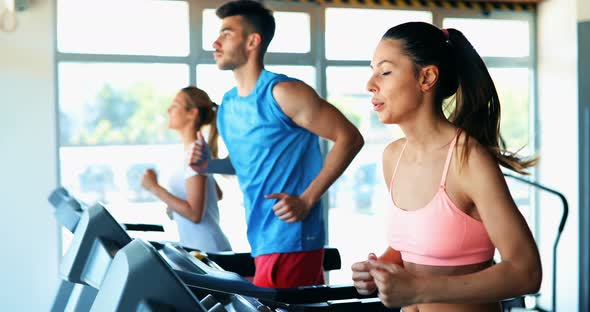 Group of Friends Exercising on Treadmill Machine