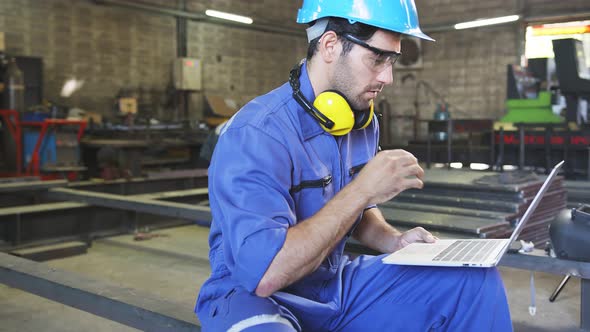 caucasian male engineer technician worker wearing safty blue helmet and uniform