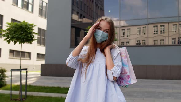 Teenager Girl with Multicolor Shopping Bags Wearing Protect Mask. Black Friday During Coronavirus