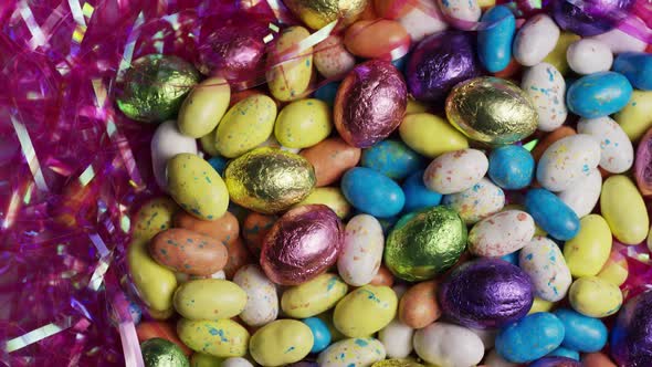 Rotating shot of colorful Easter candies on a bed of easter grass