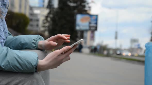 Side View of Female Hands Typing on Smartphone