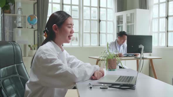 Asian Female Doctor Communicates With Patient By Video Link, Doctor Consults Patient Online