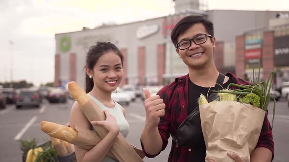 Happy Cheerful Vietnamese People Standing with Food Bags