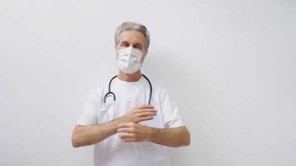 Confident Elderly Male Doctor in White Medical Uniform