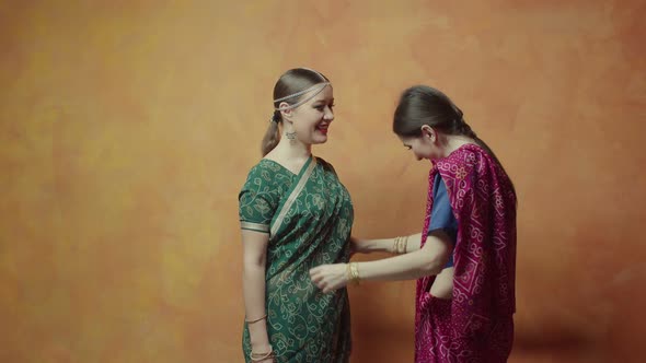 Women Friends Fitting Hindu Sari and Communicating