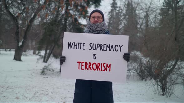 Man fighting against racism with a poster White Supremacy is Terrorism
