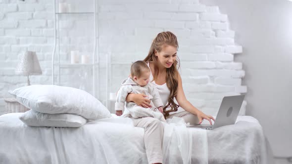 Attractive Beautiful Woman Using Laptop Holding Little Child Enjoying Motherhood