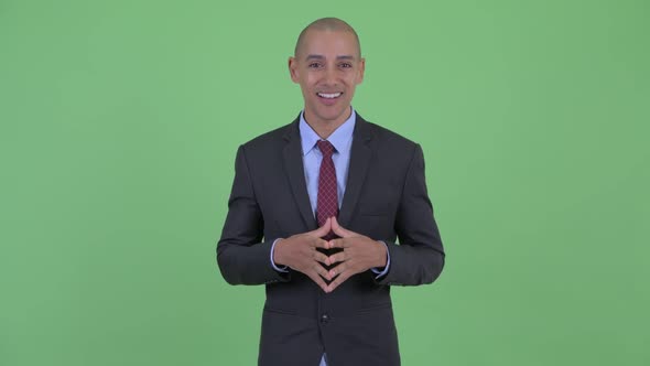 Happy Bald Multi Ethnic Businessman Presenting Something