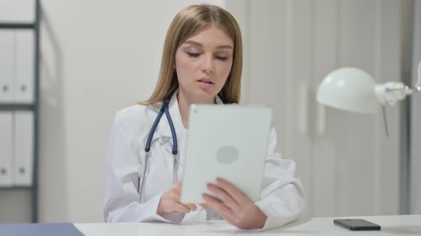 Online Video Chat on Tablet By Young Female Doctor