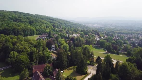 Drone shot over trees and building in Riehen, Switzerland,