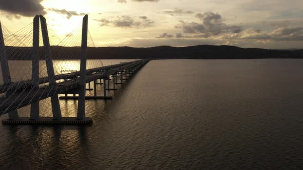 An aerial drone shot along the length of the Mario M. Cuomo Bridge on the north side. The camera dol