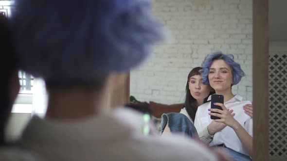 Lesbian Couple Taking Selfie in the Mirror