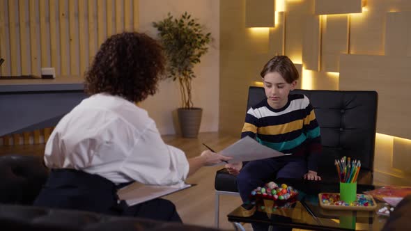 Child Psychologist Analyzing Patient's Drawing