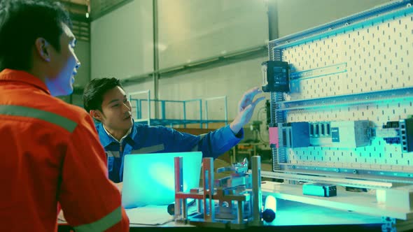 smart asian technical engineer working with assemble involved in the machine working design process