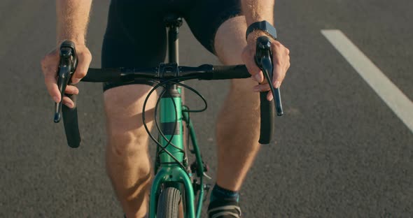 Closeup of a Bicyclist's Hands on the Steering Wheel