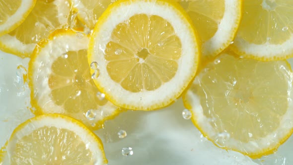 Super Slow Motion Shot of Lemon Slices Falling Into Water at 1000Fps.