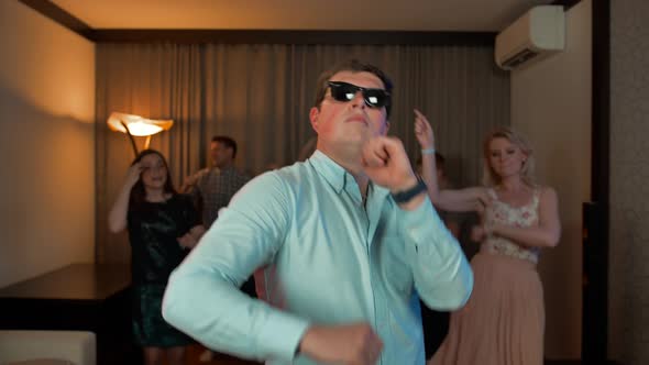 Cheerful Nerd Man with Glasses Dancing and Partying.