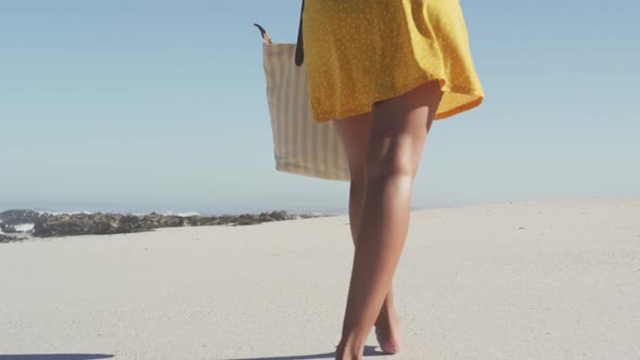 African American woman walking seaside