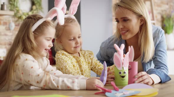 Video of mother playing with daughters using handmade Easter toys.