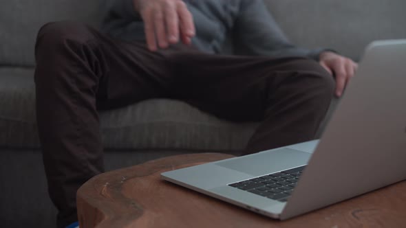 Lazy man sits on soda and can't reach the computer - gives up