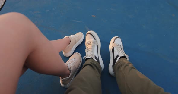 POV Male and Female Legs in Sneakers on a Tennis Court