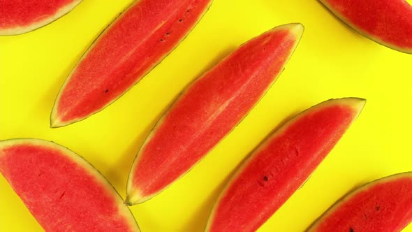 Fresh ripe watermelon slices on yellow background.