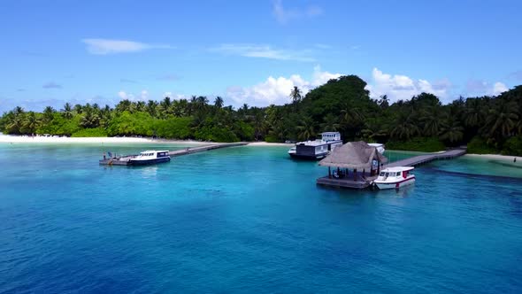 Aerial flying over travel of perfect lagoon beach journey by blue green water and white sandy backgr