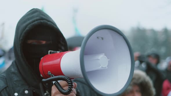 Angry Male Protester Talking with Megaphone