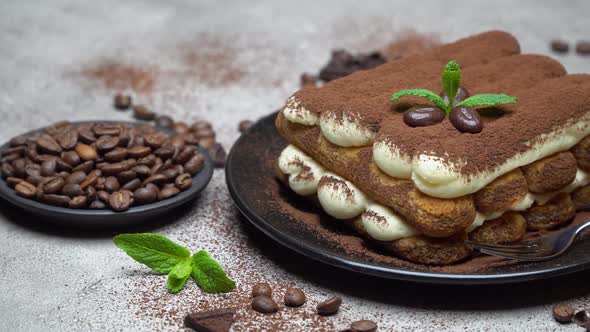 Classic Tiramisu Dessert on Ceramic Plate on Concrete Background