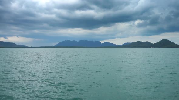 View From Moving Boat on Islands and Moody Sky