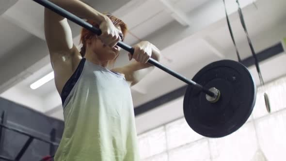 Sportswoman Doing Upright Barbell Rows