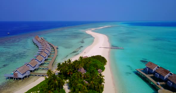 Natural birds eye copy space shot of a white sand paradise beach and aqua blue water background in h