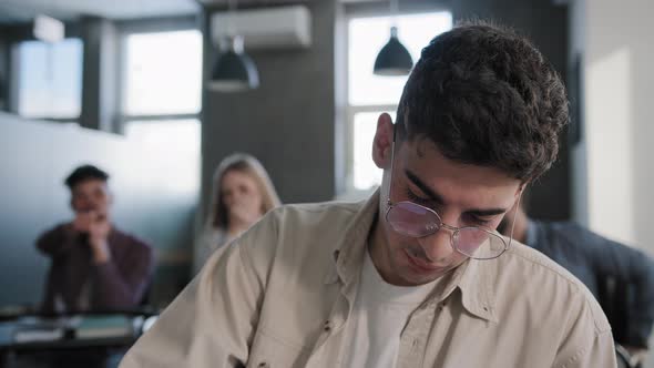 Closeup Young Depressed Student Sitting in Classroom at Desk Alone Feeling Frustrated Stress Unhappy