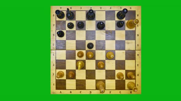 Removing chess pieces from the board after the end of the game, stop motion on a green chromakey