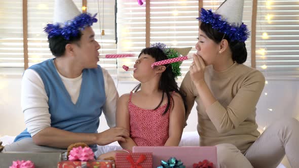 Father and mother with daughter enjoy in birthday party