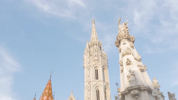 Matthias Church and fountain nearby on Buda side of Budapest against blue sky 4K 2160p UltraHD foota