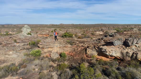 Male rock climber walking over a rocky mountain 4k