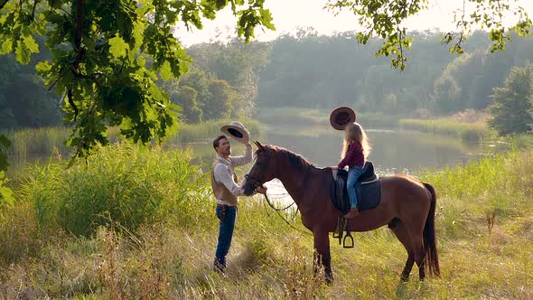 Cowboy and His Daughter on Horseback