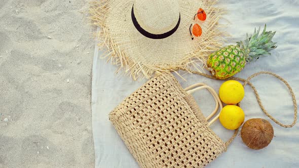 Top View Summer Female Fashion Outfit and Tropical Fruit Flat Lay on Sand