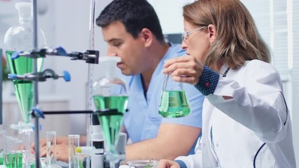 Female Laboratory Engineer Working with Her Assistant