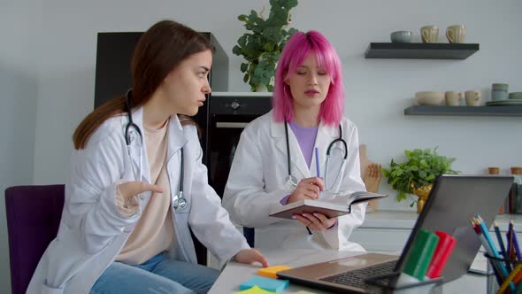 Medical Intern with Congenital Disability and Classmate Learning in Common Room