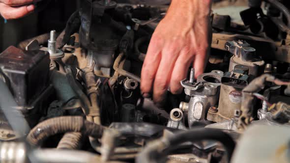 Close Up Shot of the Mechanic Repairs the Engine in  (UHD)