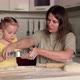 Mom Teaches Her Daughter How to Make Sweet Pastries From Dough - VideoHive Item for Sale