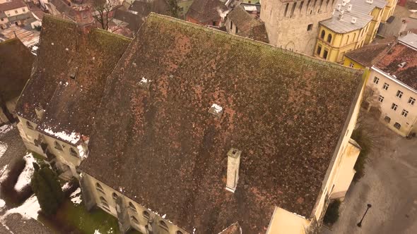 Roof top view with some snow of famous buildings in the medieval town of Sighisoara. Transylvania Ro