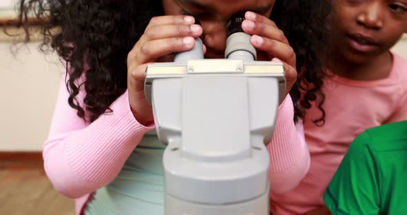 Classmates Looking Through a Microscope