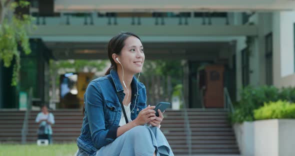 Woman listen to music on mobile phone