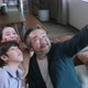 Asian family holiday activity dad holding smartphone taking a selfie photo together - VideoHive Item for Sale